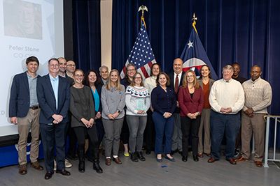 Awardees stand together at the National Ocean Service Employee Recognition Award Ceremony held in December 2024.