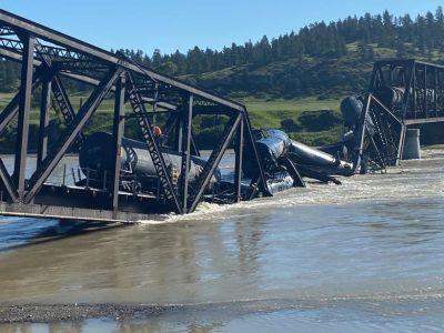 A derailed train in Reed Point, MT with rail cars carrying molten sulfur and molten asphalt sent into the Yellowstone River.