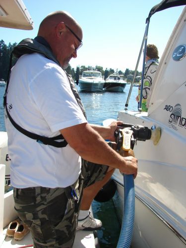 Man pumping out waste from boat. Image credit Washington Sea Grant.