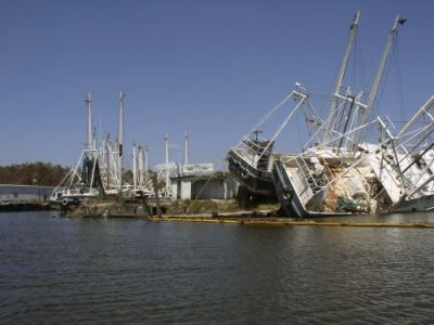 Fishing boats tilting on their sides on the water.