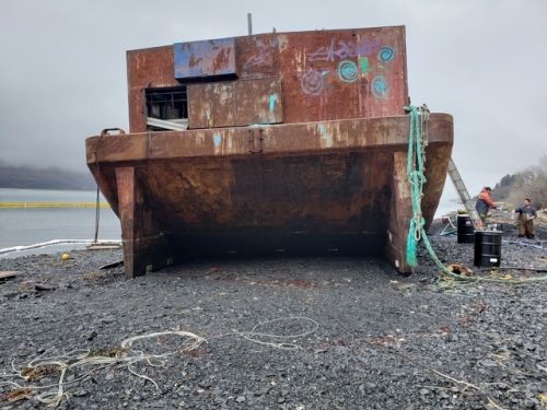 Weathered barge on a beach.