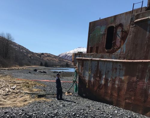 Abandoned barge on a beach.