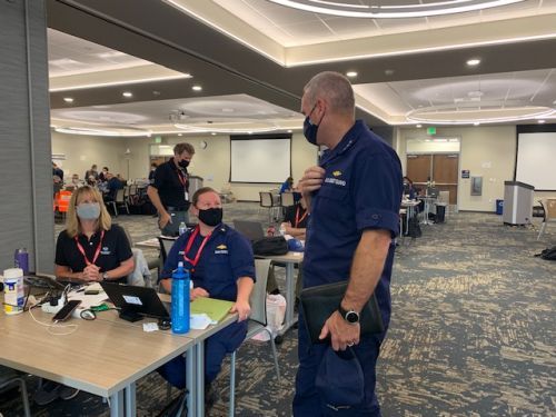 A group of people in an incident command center.