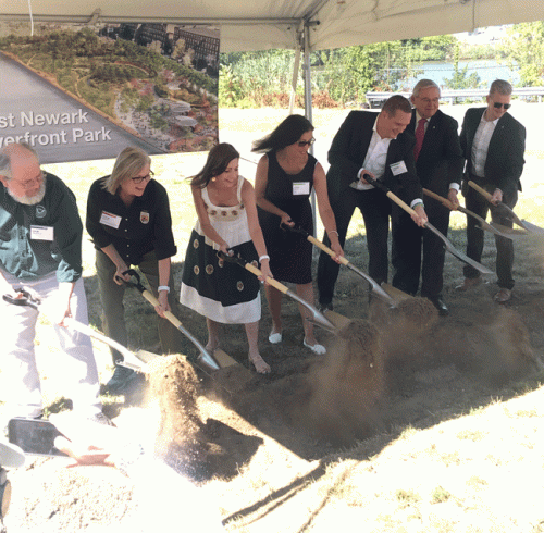 A group of people shoveling dirt.