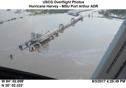 Oil slick on the water under a bridge.