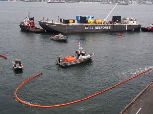 Three vessels and boom in the water.