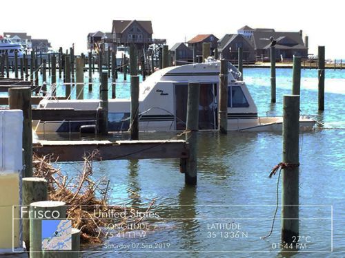 Sinking boat near a dock.