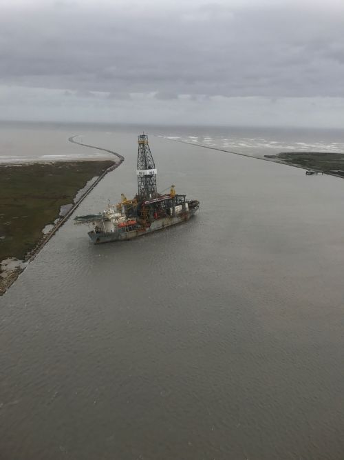 Large vessel floating in a waterway. 