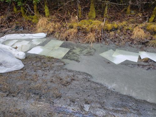 Sorbent material on spilled diesel fuel on a beach