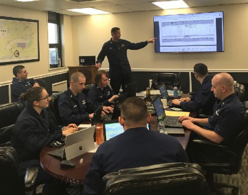 Man leading a class next to a screen