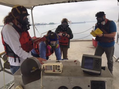 People aboard a boat doing sampling.