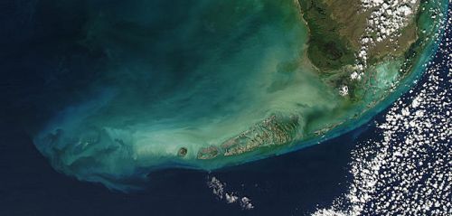 An aerial image of a land mass surrounded by water.