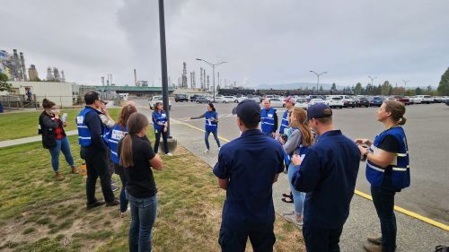 A group of people standing outside.