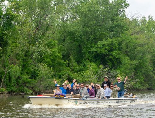 Group of people in a boat on a river.