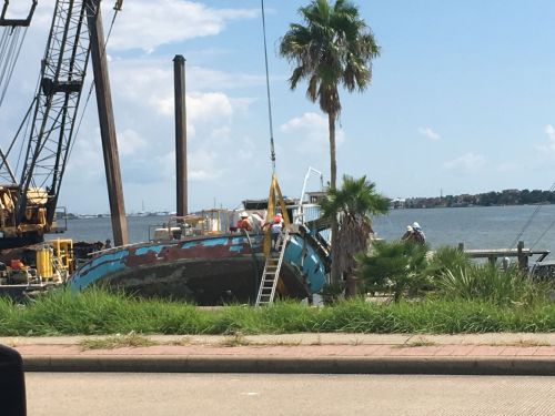 Boat near a beach in the process of being salvaged. 