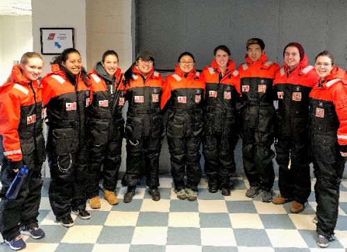 Group posing for photo in uniforms. 