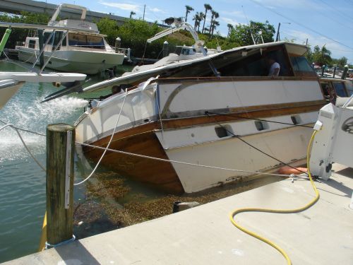 Grounded vessel next to a dock.