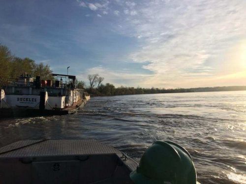 Grounded vessel by the side of the river.