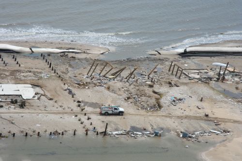Beach with destroyed structures.