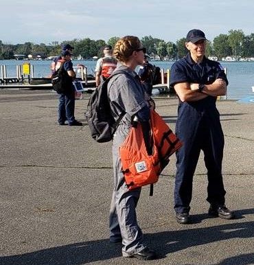 Two people conversing on a dock. 