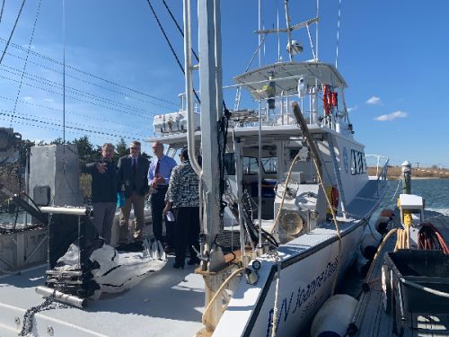 Group of people talking on a vessel.