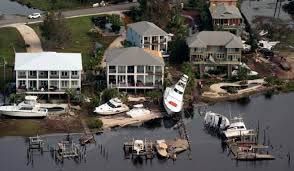 Overhead view of houses on the water, docks and boats.