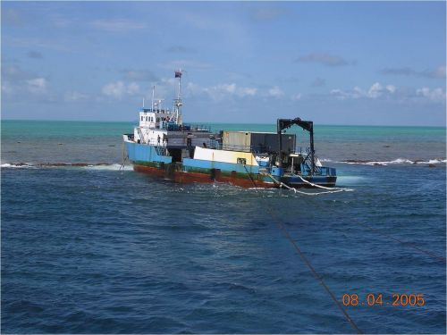 Large vessel, listing near the shore.