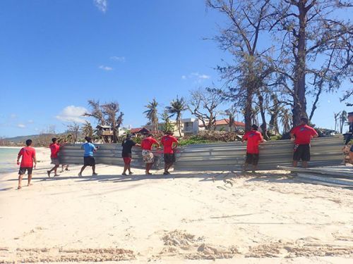 Several people working on a beach.