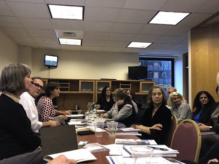 People seated around a conference table. 