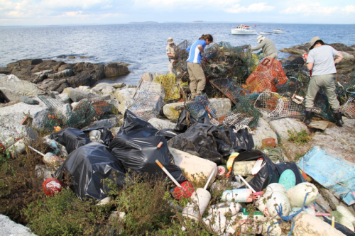 People among bags of trash.