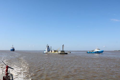 Three vessels around a barge. 