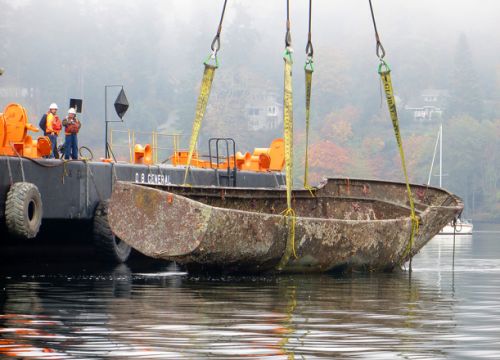 A boat being raised from the water.