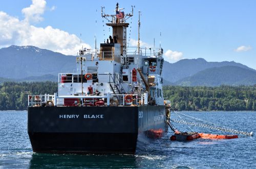 Vessel in the water with a skimmer attached.