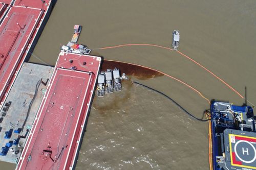 Aerial view of skimmer boats and skimming equipment.