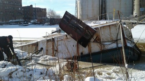 Sinking vessel near an industrial area. 