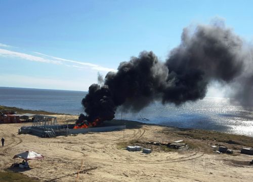 Initial testing of burn pan at Joint Maritime Test Facility located in Mobile, Alabama, on Little Sand Island, November 2015. Black smoke rising from an area near a beach.