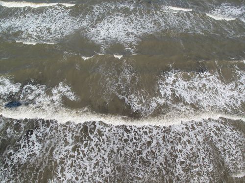 Overhead view of oil in the surf.