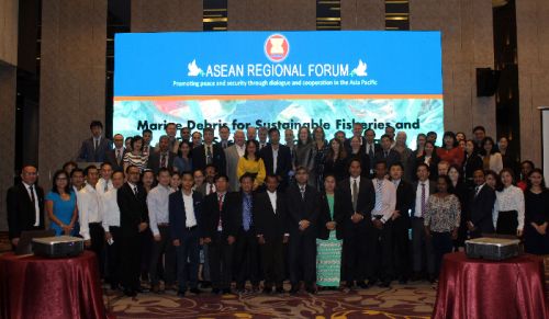 Group posing in front of a screen.