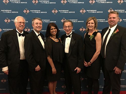 Six people pose for photo.