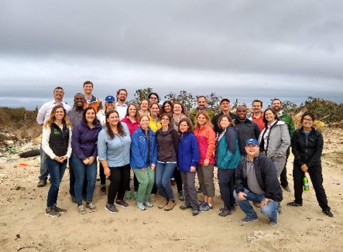 Group posing outdoors for photo.