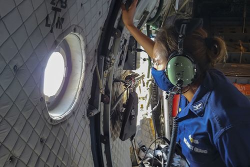 Woman looking out the window of a plane. 