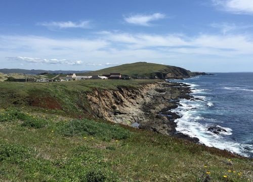 Buildings on a bluff next to ocean.