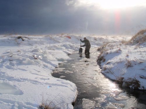 Adak oil spill sampling Two people sampling in a stream after the Adak oil spill.