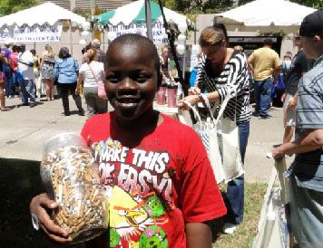 Boy holding jar of cigarette butts.