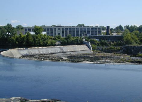 Manufacturing plant on the edge of a dammed river.