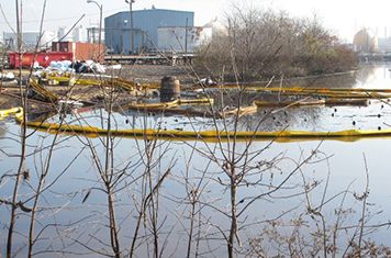 Containment boom surrounds the oil and debris released from tanks in New Jersey.