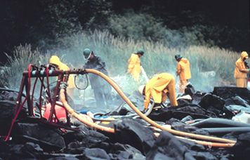 Pressure cleaning intertidal rocks in Prince William Sound, Alaska.