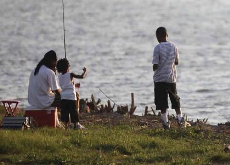 A family fishes on the Anacostia River near Washington, D.C. (NOAA)