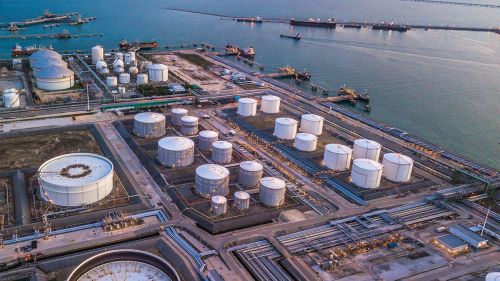 Aerial view of an industrial facility with several large-scale chemical storage tanks.