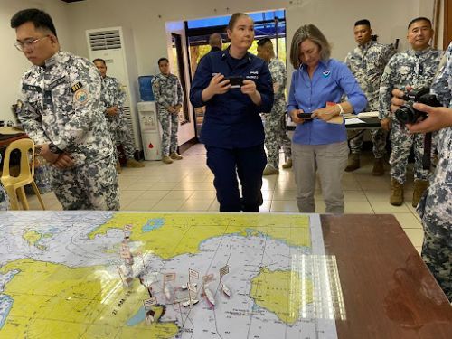 A group of people looking at a map.